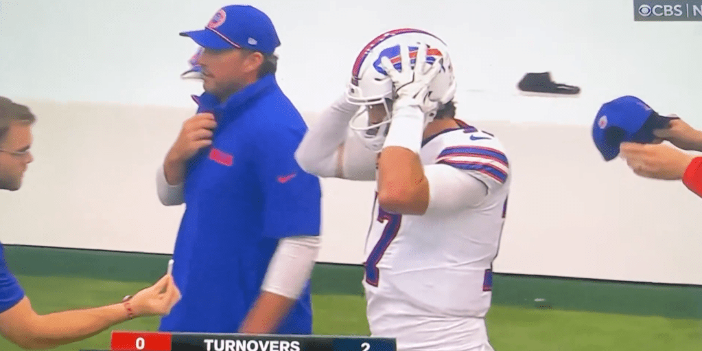 Josh Allen is offered smelling salts after a hard hit Sunday.